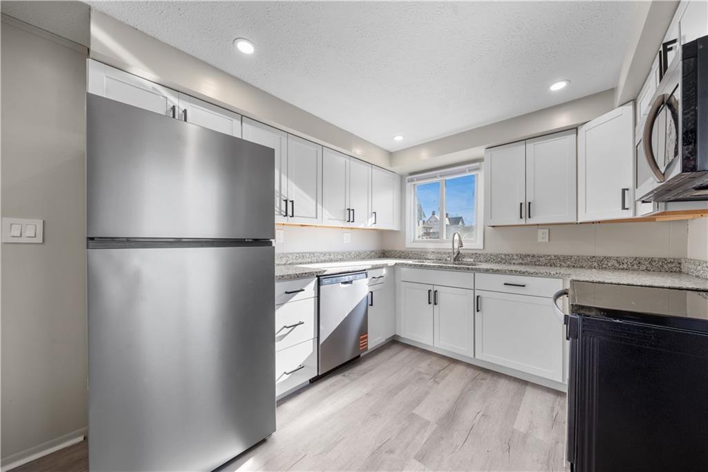 116 4th Street McDonald, PA 15057 - Photo 3 of 16 a kitchen with white cabinets and refrigerator