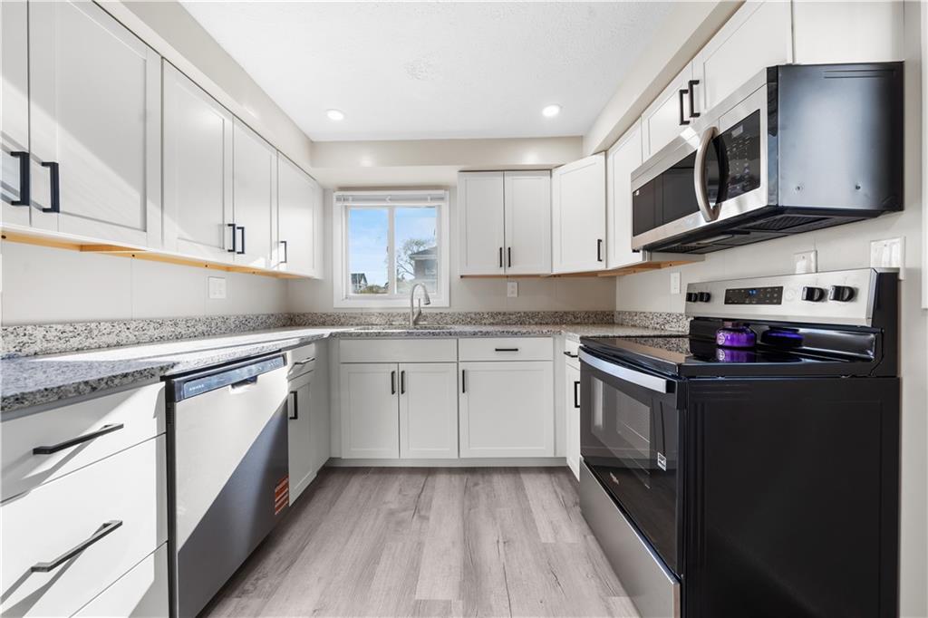 116 4th Street McDonald, PA 15057 - Photo 4 of 16 a kitchen with stainless steel appliances granite countertop a stove a sink and a microwave