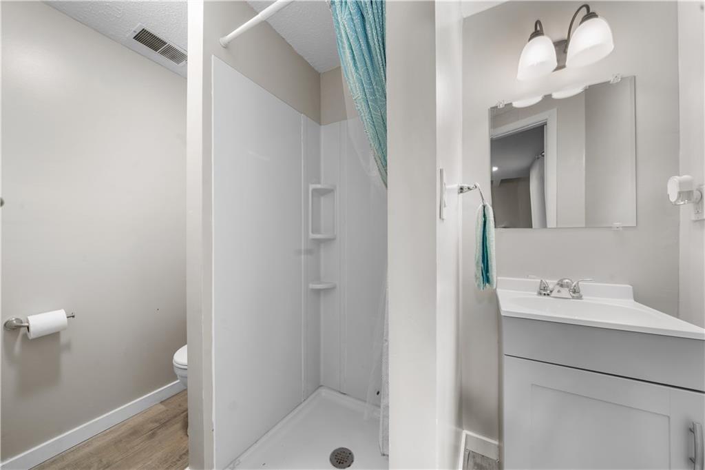 116 4th Street McDonald, PA 15057 - Photo 10 of 16 a bathroom with a sink a mirror and a shower