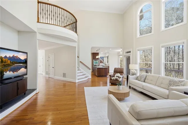 a bathroom with a granite countertop sink and mirror with bathtub