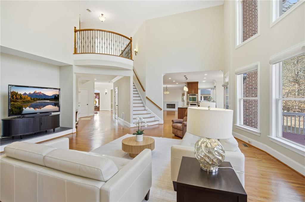 715 Crown Cove Milton, GA 30004 - Photo 23 of 102 a living room with furniture and wooden floor