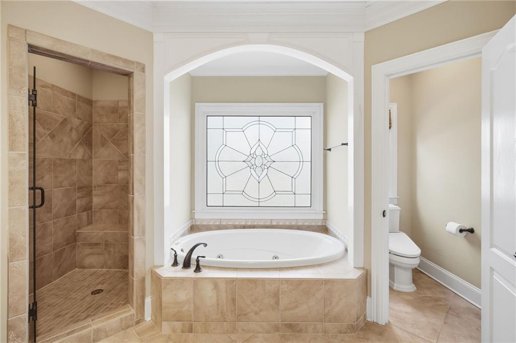 715 Crown Cove Milton, GA 30004 - Photo 34 of 102 a bathroom with a granite countertop bathtub shower and toilet