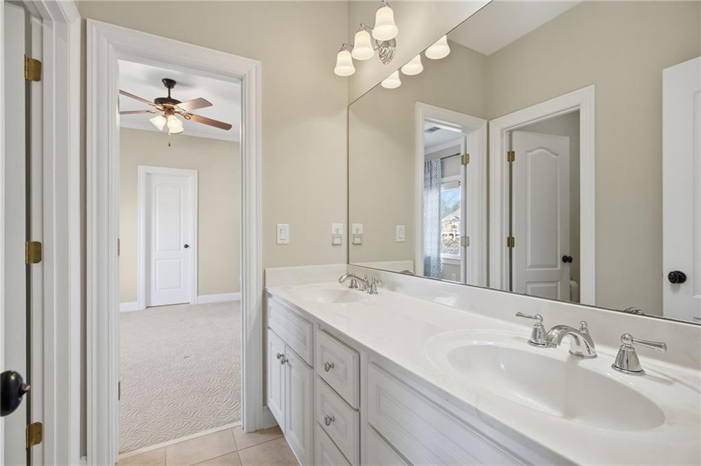 715 Crown Cove Milton, GA 30004 - Photo 40 of 102 a bathroom with a double vanity sink and a mirror