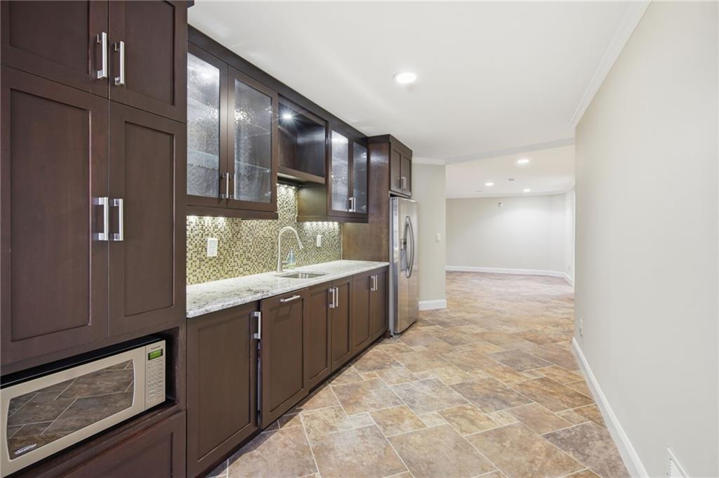 715 Crown Cove Milton, GA 30004 - Photo 43 of 102 a large bathroom with a large mirror vanity and shower