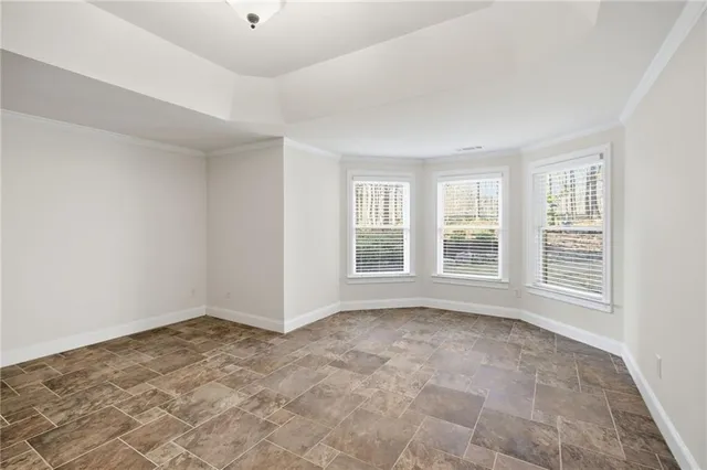 a view of a swimming pool with a lawn chairs and potted plants