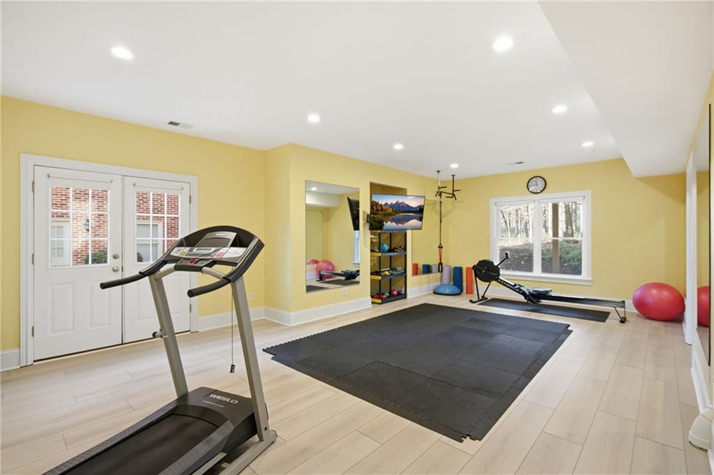715 Crown Cove Milton, GA 30004 - Photo 50 of 102 a room with gym equipment and a large window