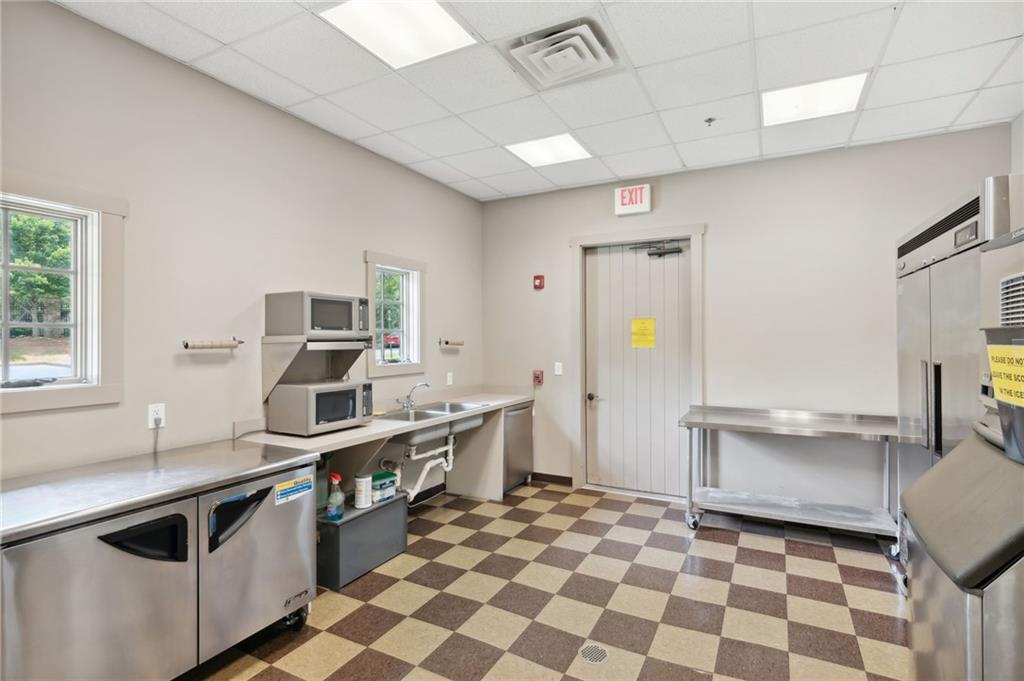 715 Crown Cove Milton, GA 30004 - Photo 76 of 102 a kitchen with a sink stove and cabinets