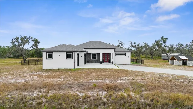 front view of a brick house with a yard