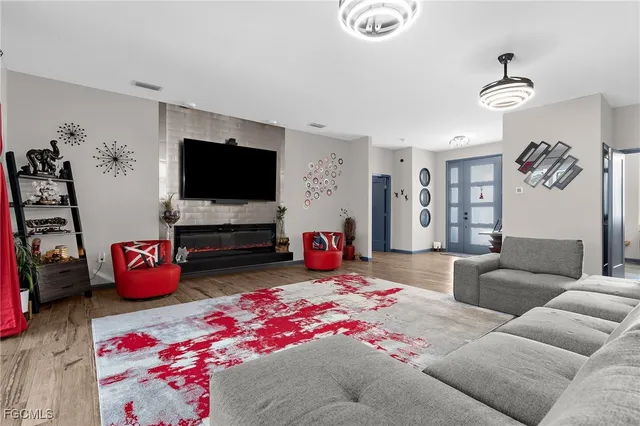 a reading room with wooden floor and furniture