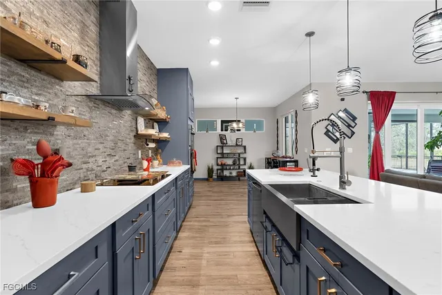 a kitchen with a stove a sink dishwasher a kitchen island with wooden cabinets and floor