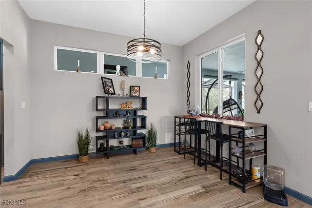 a view of a dining room with furniture clothes and chandelier