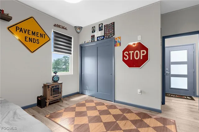 a view of a hallway with wooden floor and closet