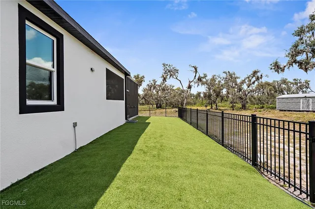 a view of a patio with a table and chairs next to a yard