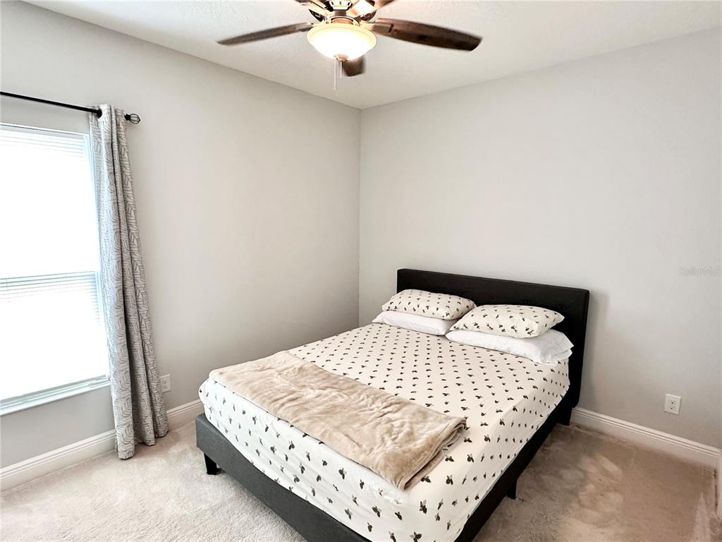 207 Petosky Road Groveland, FL 34736 - Photo 16 of 21 a bedroom with a bed and window