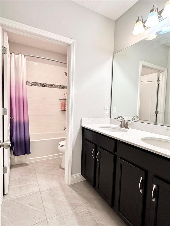 207 Petosky Road Groveland, FL 34736 - Photo 17 of 21 a bathroom with a double vanity sink a toilet and a mirror