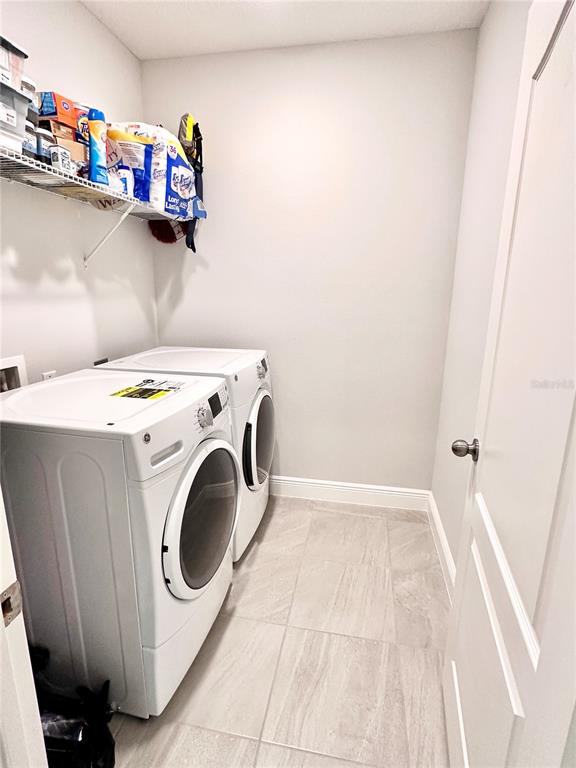 207 Petosky Road Groveland, FL 34736 - Photo 18 of 21 a utility room with dryer and washer