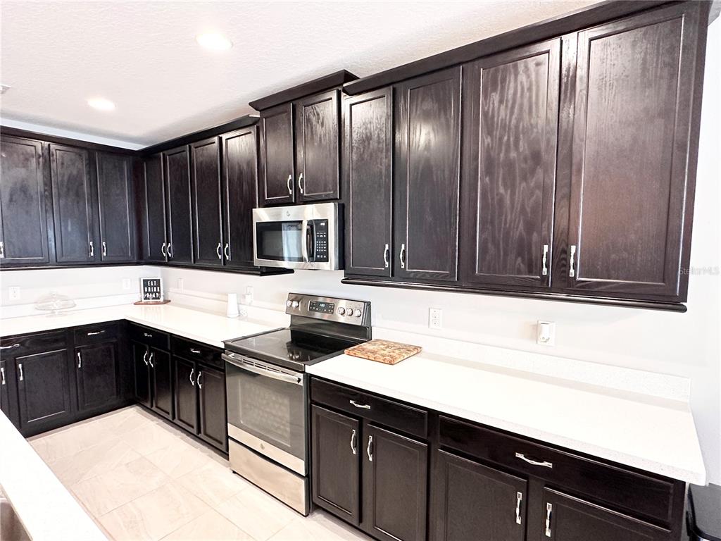 207 Petosky Road Groveland, FL 34736 - Photo 5 of 21 a kitchen with a sink a stove and cabinets