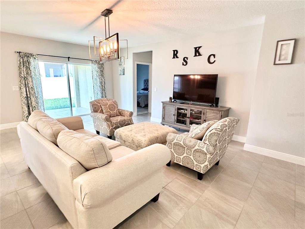 207 Petosky Road Groveland, FL 34736 - Photo 9 of 21 a living room with furniture and a flat screen tv