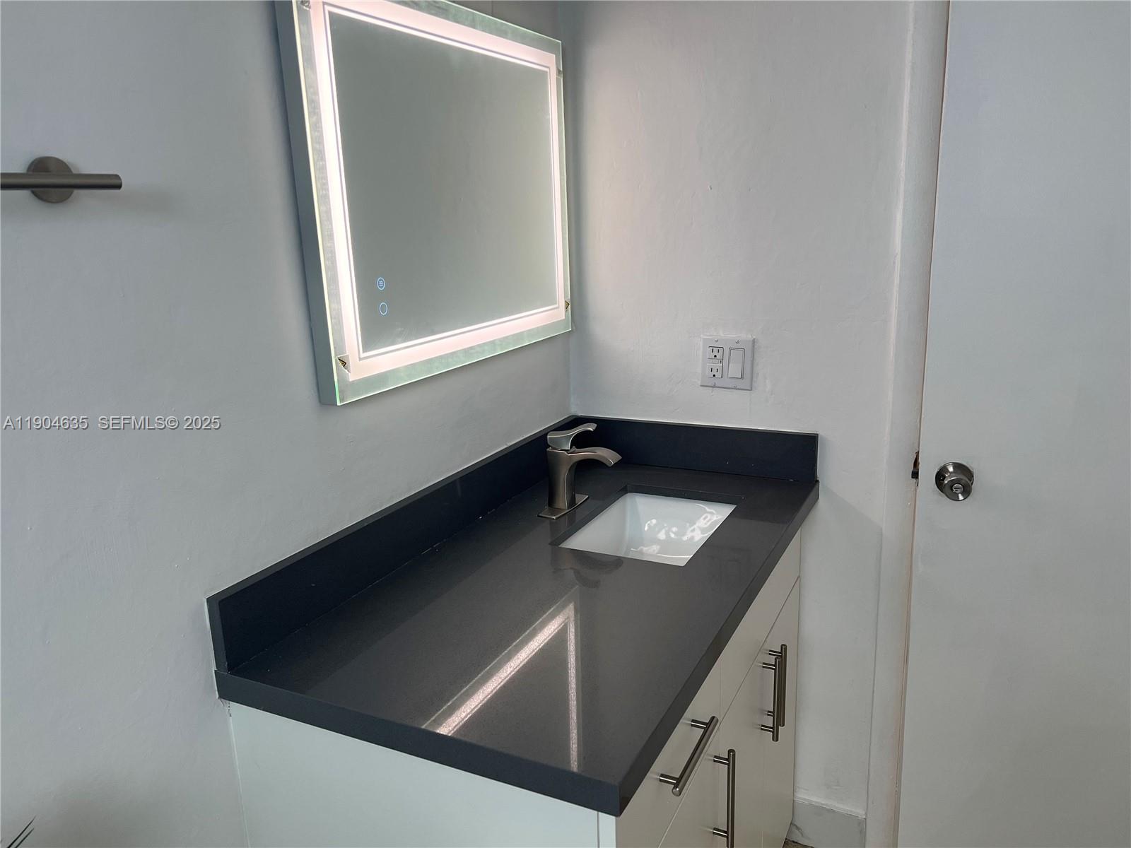1012 Southwest 4th Avenue, Unit 3 Miami, FL 33130 - Photo 7 of 16 a bathroom with a sink and a mirror