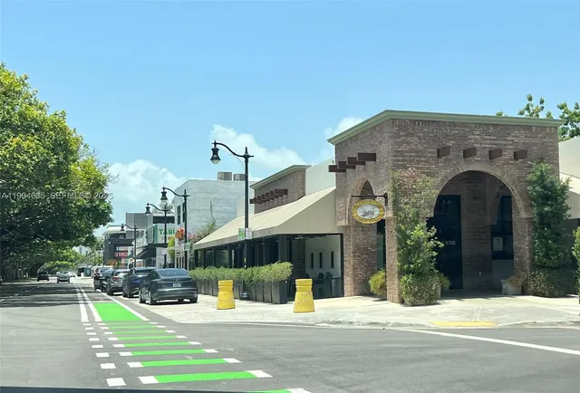 a view of a building with a garden and pathway