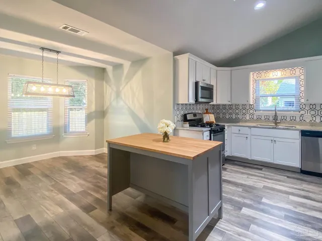 a kitchen with a sink cabinets and window