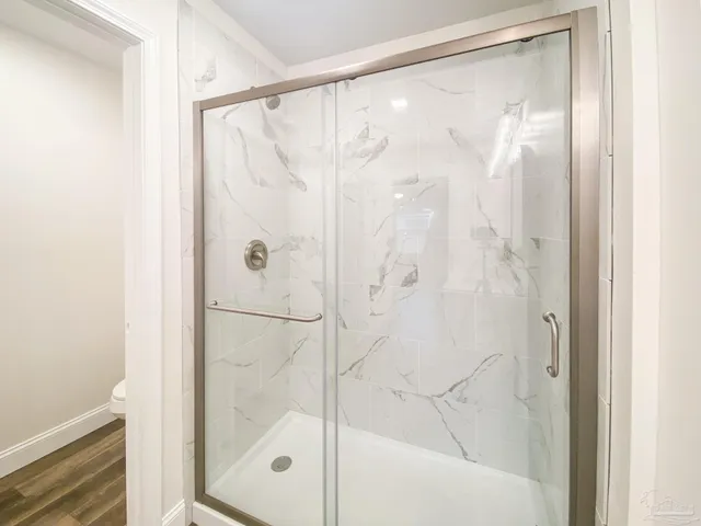 a bathroom with a glass shower door