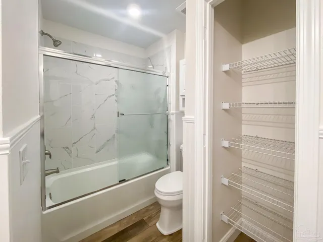 a bathroom with a shower and a toilet