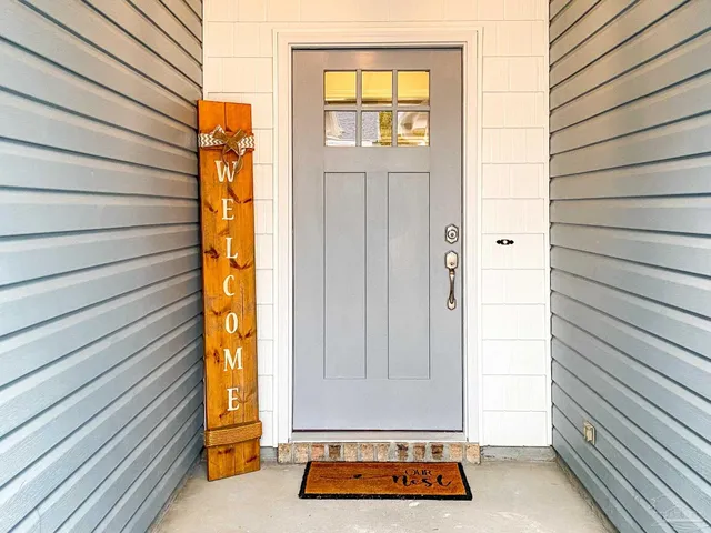 a view of front door and porch with furniture