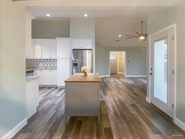 a kitchen with kitchen island a sink stainless steel appliances and cabinets