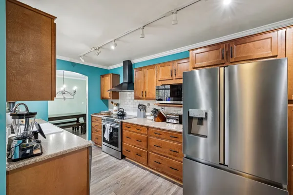 a kitchen with stainless steel appliances a refrigerator stove and sink