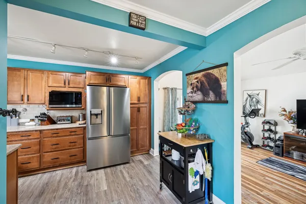 a kitchen with stainless steel appliances granite countertop a refrigerator and a stove top oven