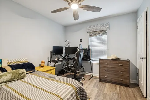 a bedroom with a bed and wooden floor