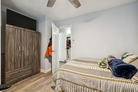 a bedroom with a bed and a window