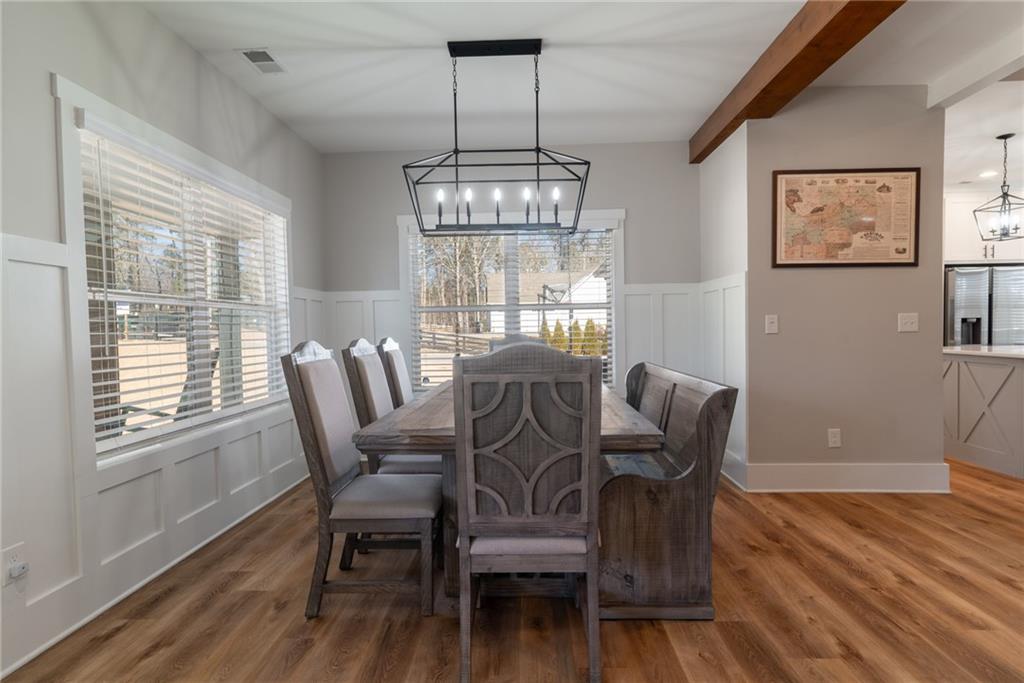 2250 Sperin Road Ball Ground, GA 30107 - Photo 15 of 56 a view of a dining room with furniture window and wooden floor
