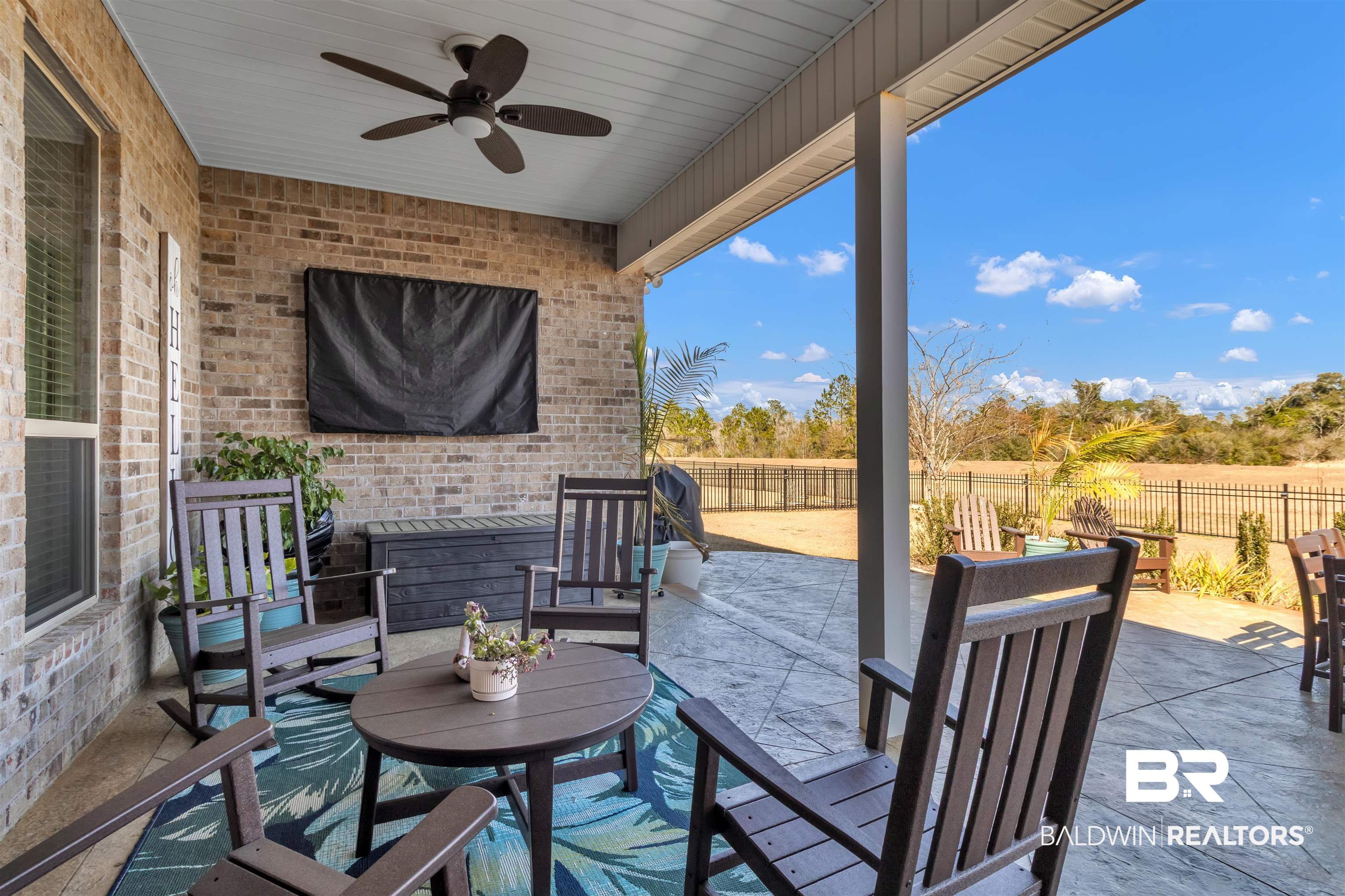 22531 Putter Lane Foley, AL 36535 - Photo 7 of 43 Fenced backyard with ceiling fan, a patio, and an outdoor lounge area