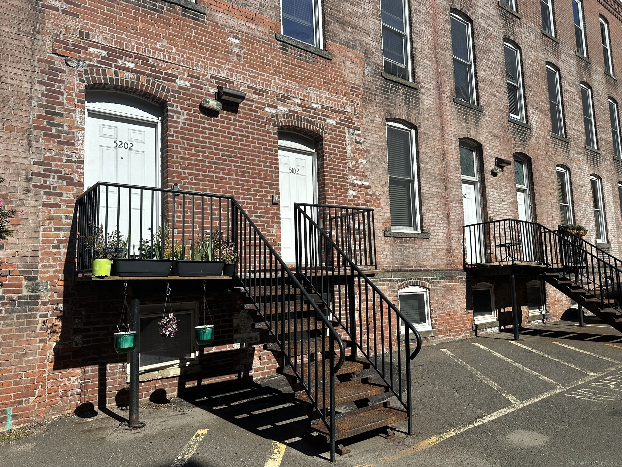 front view of a brick house with a small yard