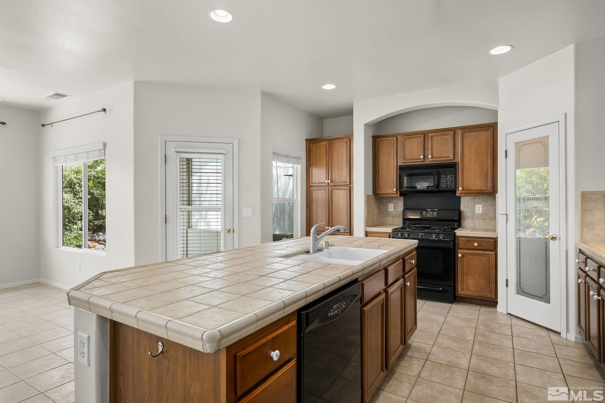1439 Gaucho Lane Reno, NV 89521 - Photo 13 of 40 a kitchen with a stove a sink a refrigerator and a wooden cabinets