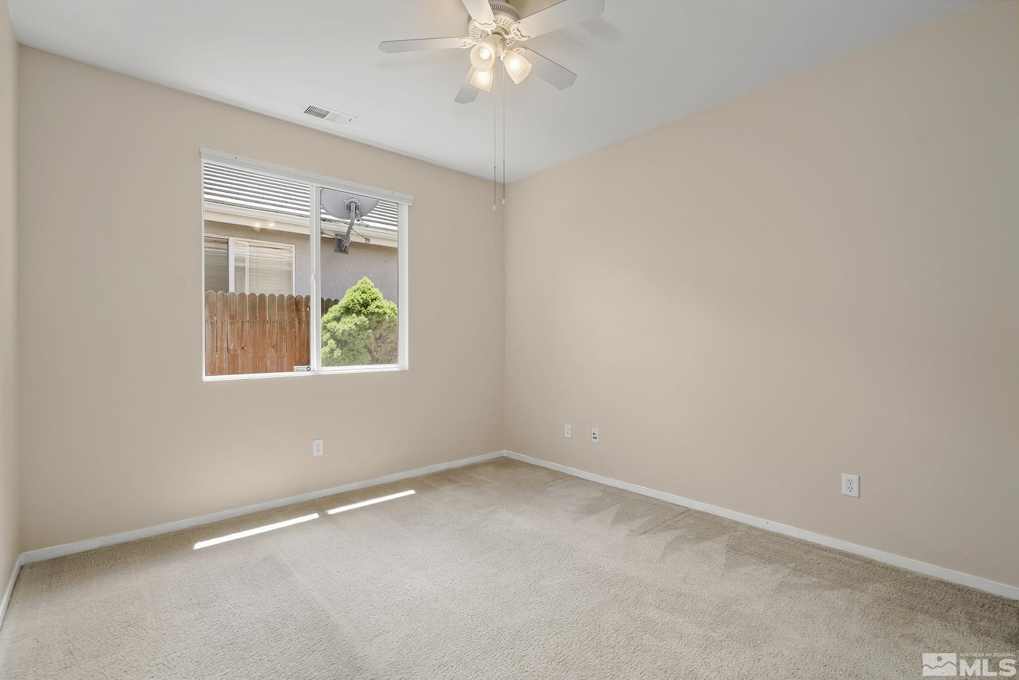 1439 Gaucho Lane Reno, NV 89521 - Photo 20 of 40 an empty room with a window and ceiling fan