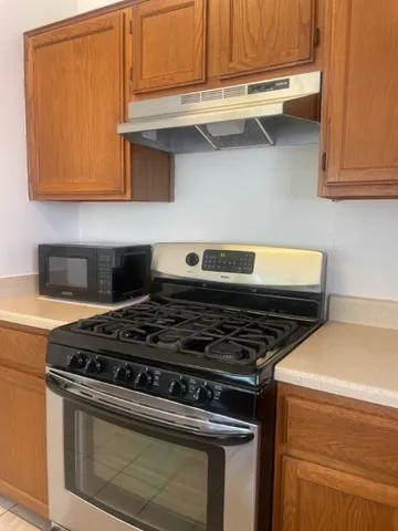 a stove top oven sitting inside of a kitchen