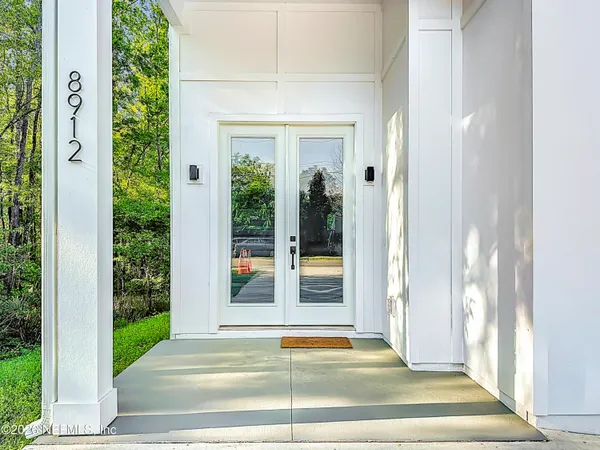 a view of an entryway with wooden floor and windows