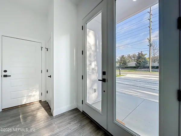 a large kitchen with granite countertop a sink and dishwasher a stove with wooden floors