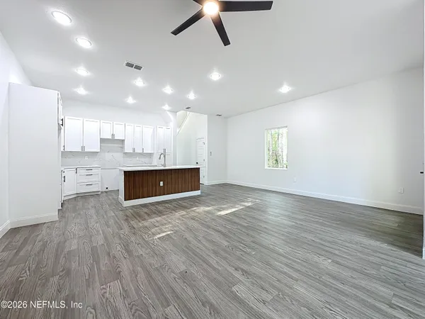 a view of hallway with wooden floor