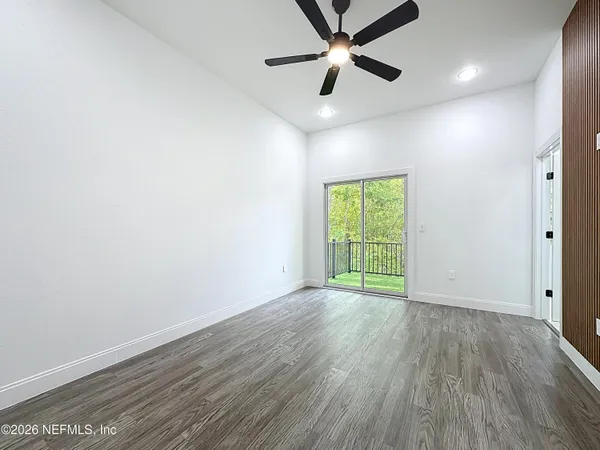 a spacious bathroom with a shower sink and mirror