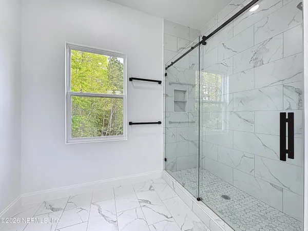 an empty room with ceiling window and wooden floor
