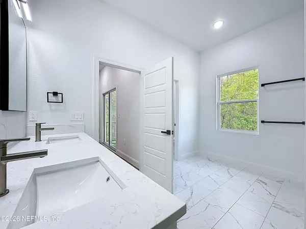 an empty room with ceiling fan and window