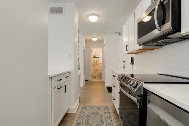 5701 North Sheridan Road, Unit 4R Chicago, IL 60660 - Photo 11 of 18 a kitchen with stainless steel appliances a stove and a refrigerator