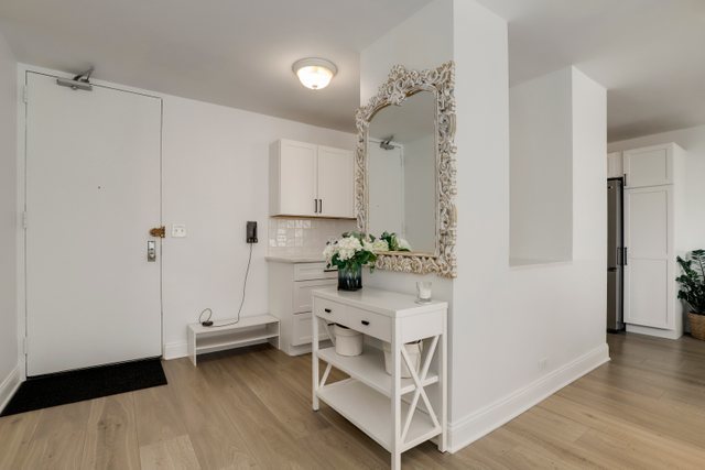 5701 North Sheridan Road, Unit 4R Chicago, IL 60660 - Photo 16 of 18 a view of white cabinets and wooden floor