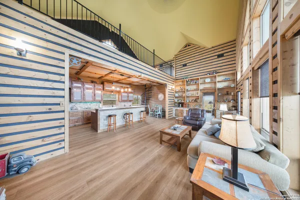 a kitchen with stainless steel appliances granite countertop a refrigerator a stove and a wooden floors