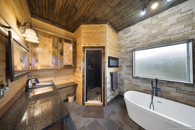a bathroom with a tub and a sink