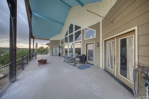 a view of a porch with chairs and backyard